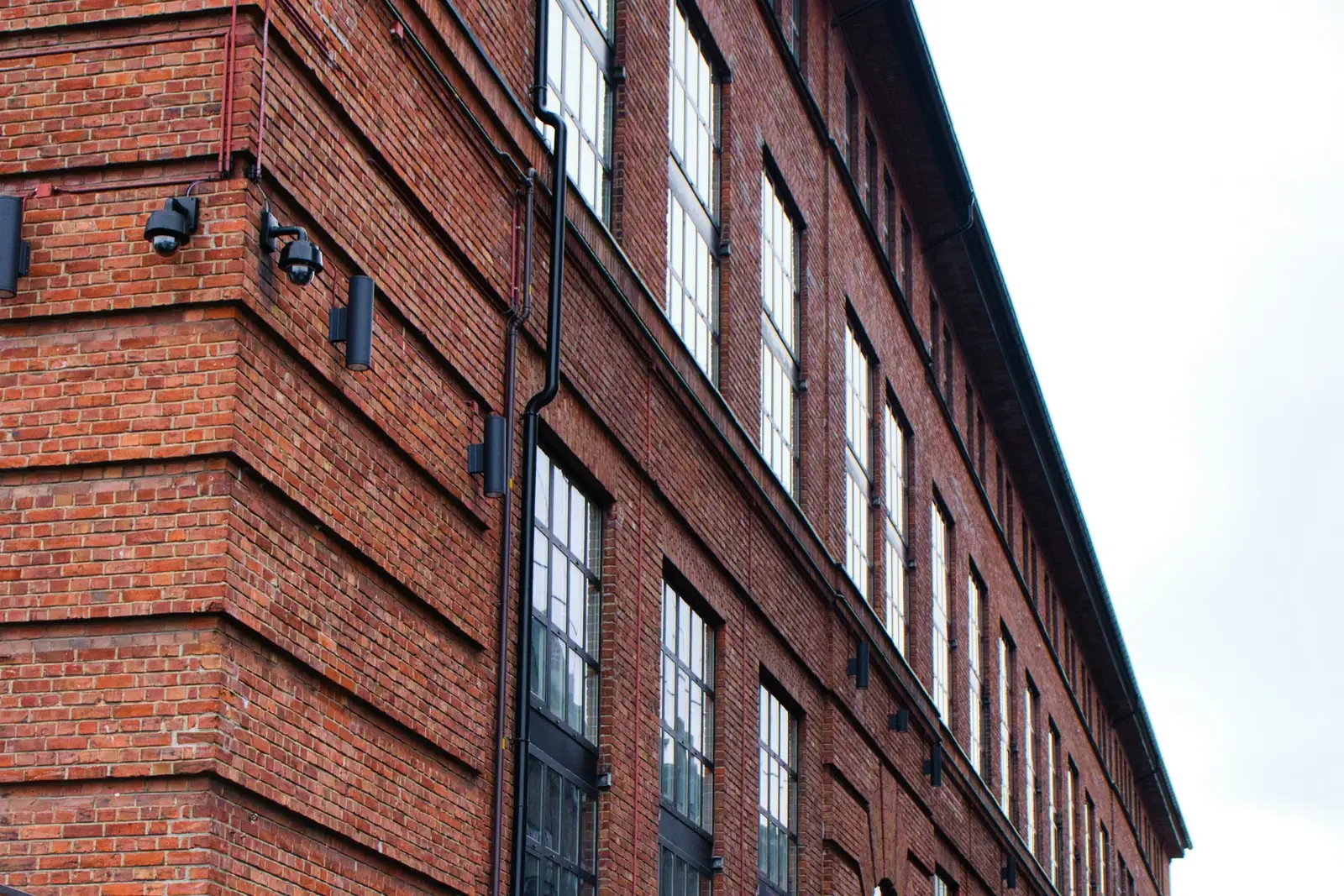 An old brick commercial building with rows of large windows