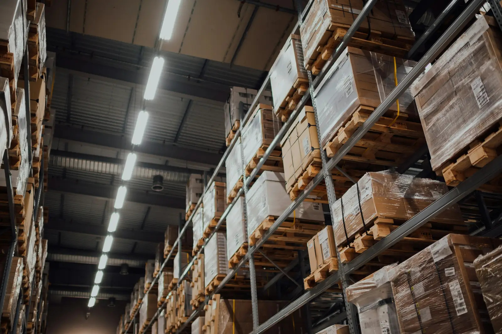 Cardboard boxes of stock stacked on warehouse racking